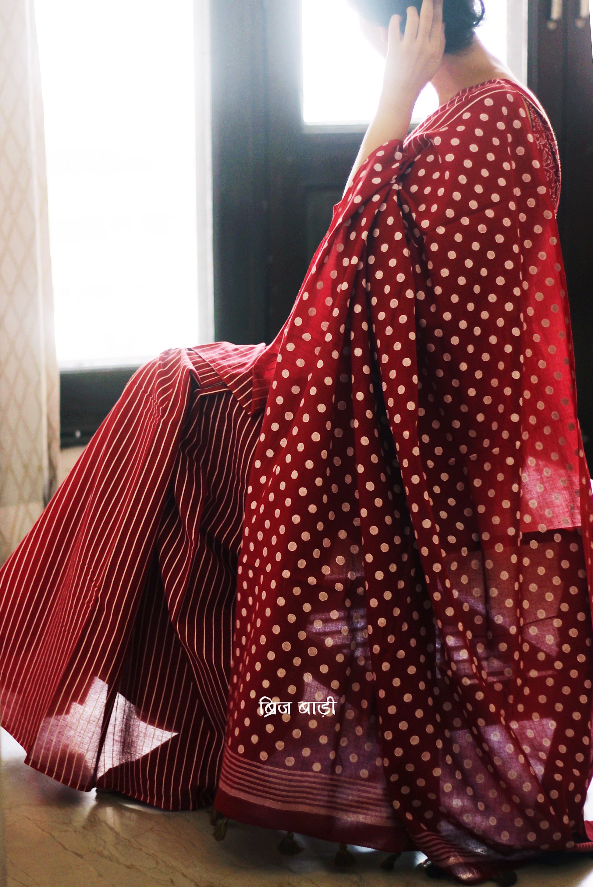 Deep Red cotton saree with bold hand block printed stripes and polka dots, artisan-crafted in breathable fabric. Includes matching printed blouse piece.

