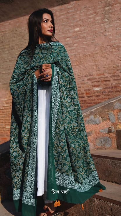 Dark green soft and lightweight cotton dupatta by Brij Bari, hand block printed with a beautiful floral pattern that brings out its artisanal charm. Finished with handcrafted mustard thread tassels on both ends of the pallu, this dupatta offers breathable comfort and a versatile look that pairs beautifully with everyday suits. Free shipping pan India.







