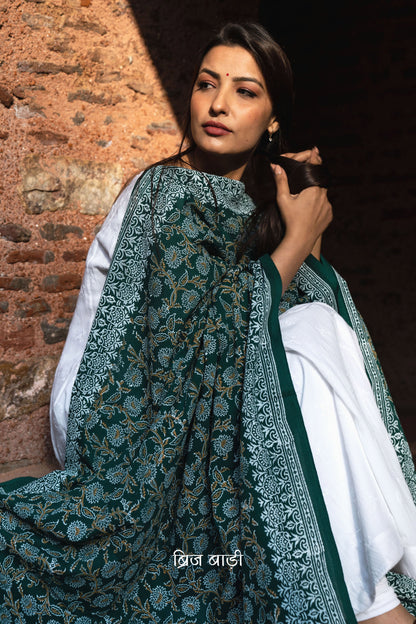 Dark green soft and lightweight cotton dupatta by Brij Bari, hand block printed with a beautiful floral pattern that brings out its artisanal charm. Finished with handcrafted mustard thread tassels on both ends of the pallu, this dupatta offers breathable comfort and a versatile look that pairs beautifully with everyday suits. Free shipping pan India.








