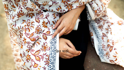 Off white soft and lightweight cotton dupatta by Brij Bari, hand block printed with a vibrant multicolour floral pattern. Finished with handmade purple thread tassels on both ends of the pallu, this artisanal dupatta adds a lively pop of colour to your daily suits while offering all-day breathable comfort. Ideal for versatile styling. Free shipping pan India.