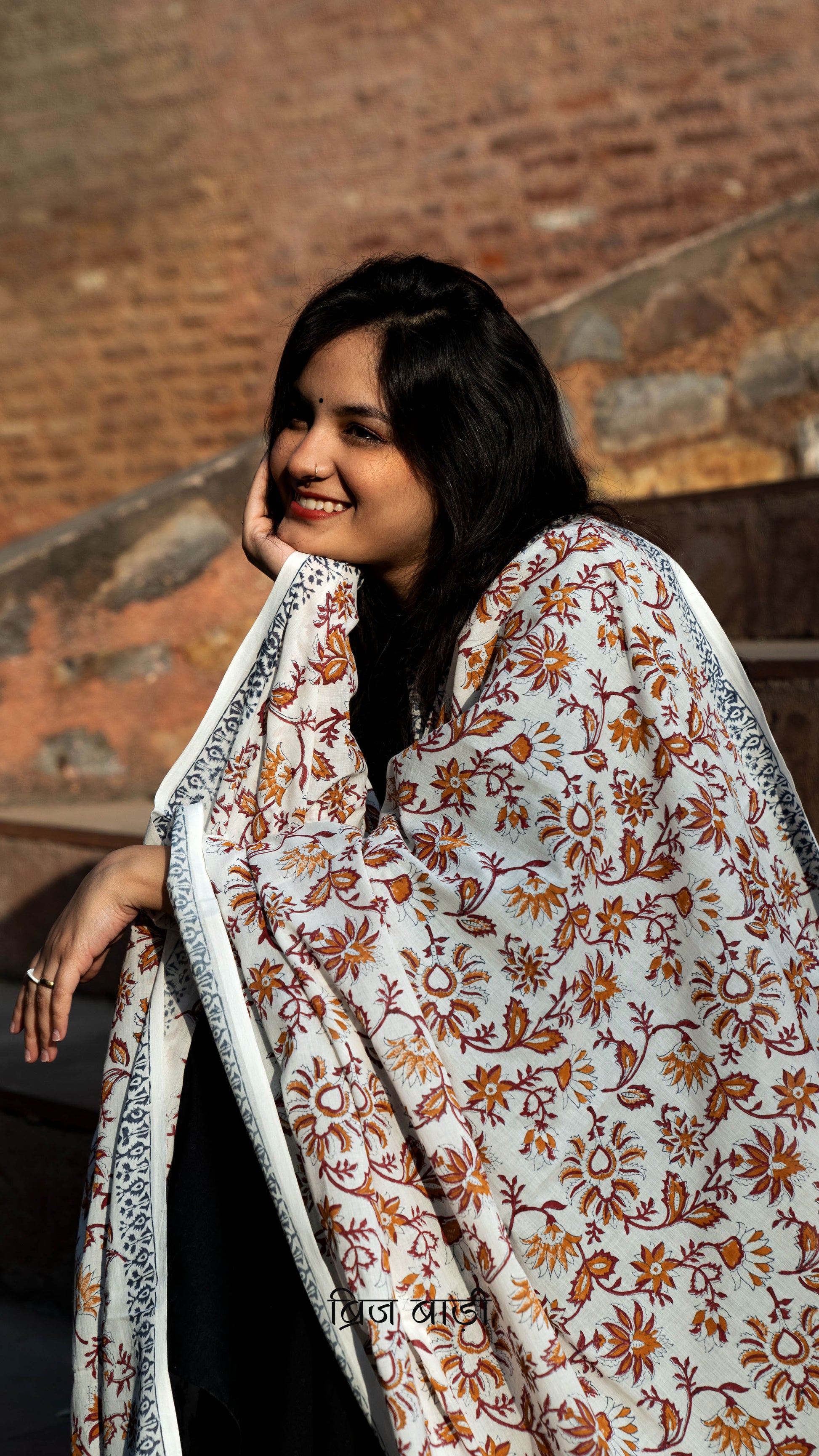 Off white soft and lightweight cotton dupatta by Brij Bari, hand block printed with a vibrant multicolour floral pattern. Finished with handmade purple thread tassels on both ends of the pallu, this artisanal dupatta adds a lively pop of colour to your daily suits while offering all-day breathable comfort. Ideal for versatile styling. Free shipping pan India.