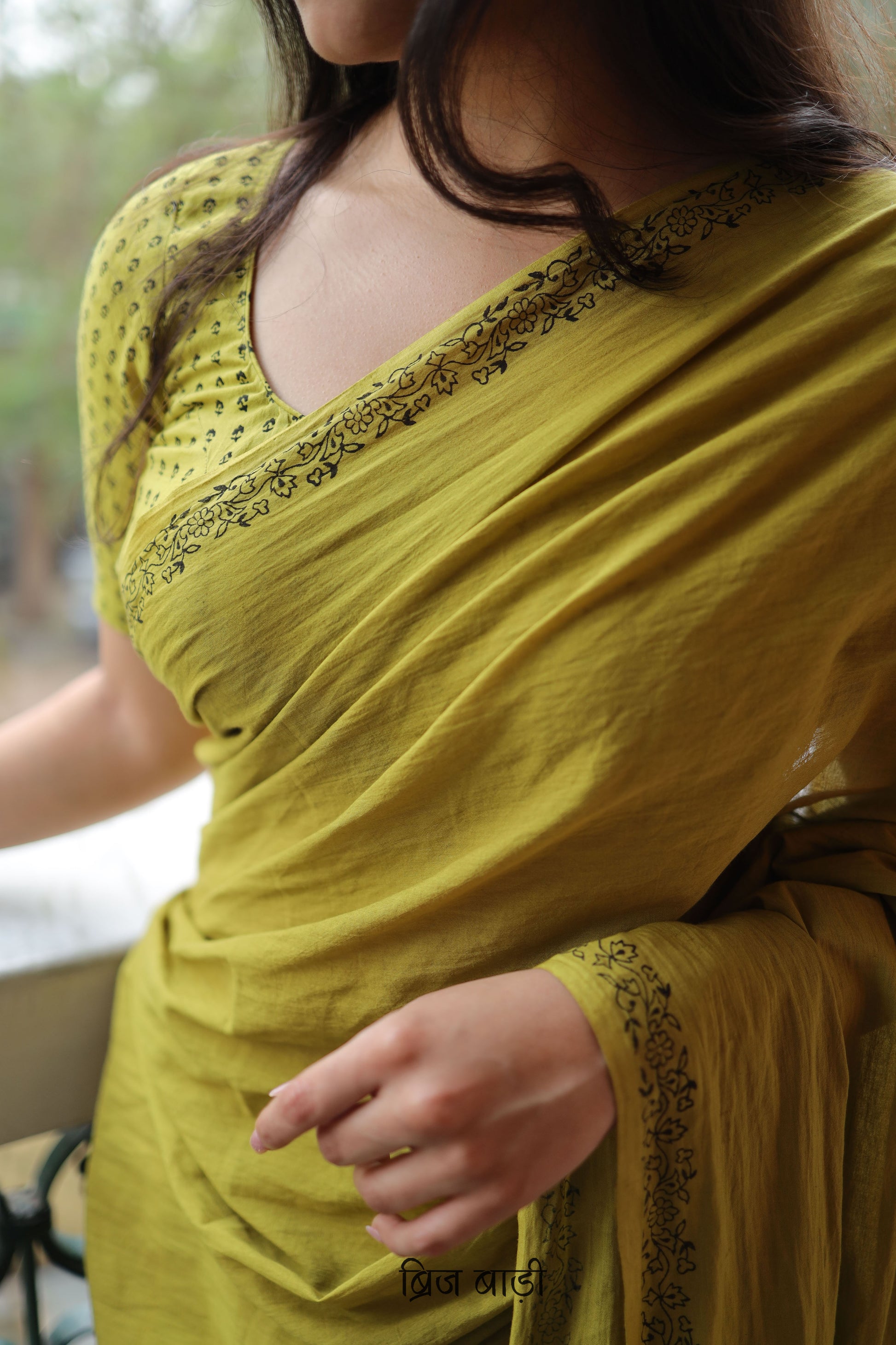 Light green soft and light-weight cotton saree by Brij Bari with a simple & elegant hand block printed border in classic black. Crafted in breathable, airy cotton, this saree is ideal for everyday wear — offering ease, comfort, and timeless style for work, casual days or relaxed occasions. The pallu is beautifully finished with purple handmade thread tassels, adding a playful, artisanal touch. It comes with a free hand block printed blouse piece