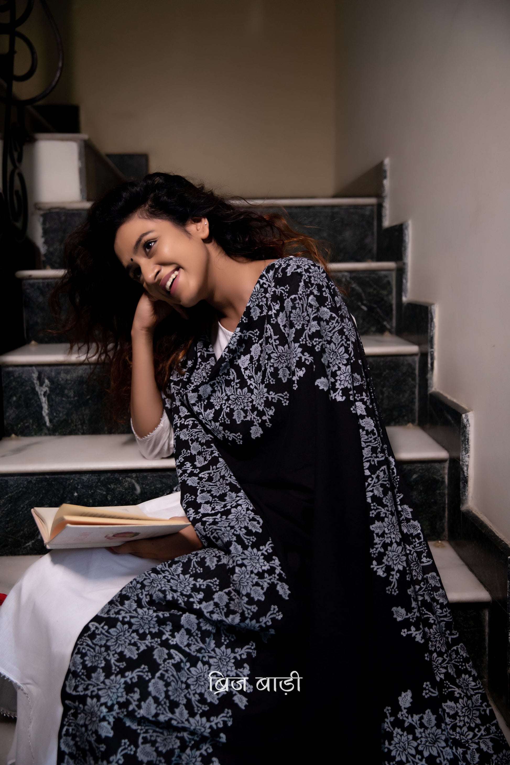 Black soft and light-weight cotton dupatta by Brij Bari, adorned with an elegant floral border hand block printed in crisp white, creating a striking contrast against the deep black base. Crafted from breathable, airy cotton fabric, this dupatta is ideal to pair with suits, kurtas, or ethnic sets, adding a refined handcrafted touch to both everyday and occasion wear. The pallu is finished with vibrant red handmade thread tassels, offering a playful, artisanal accent to the look. 