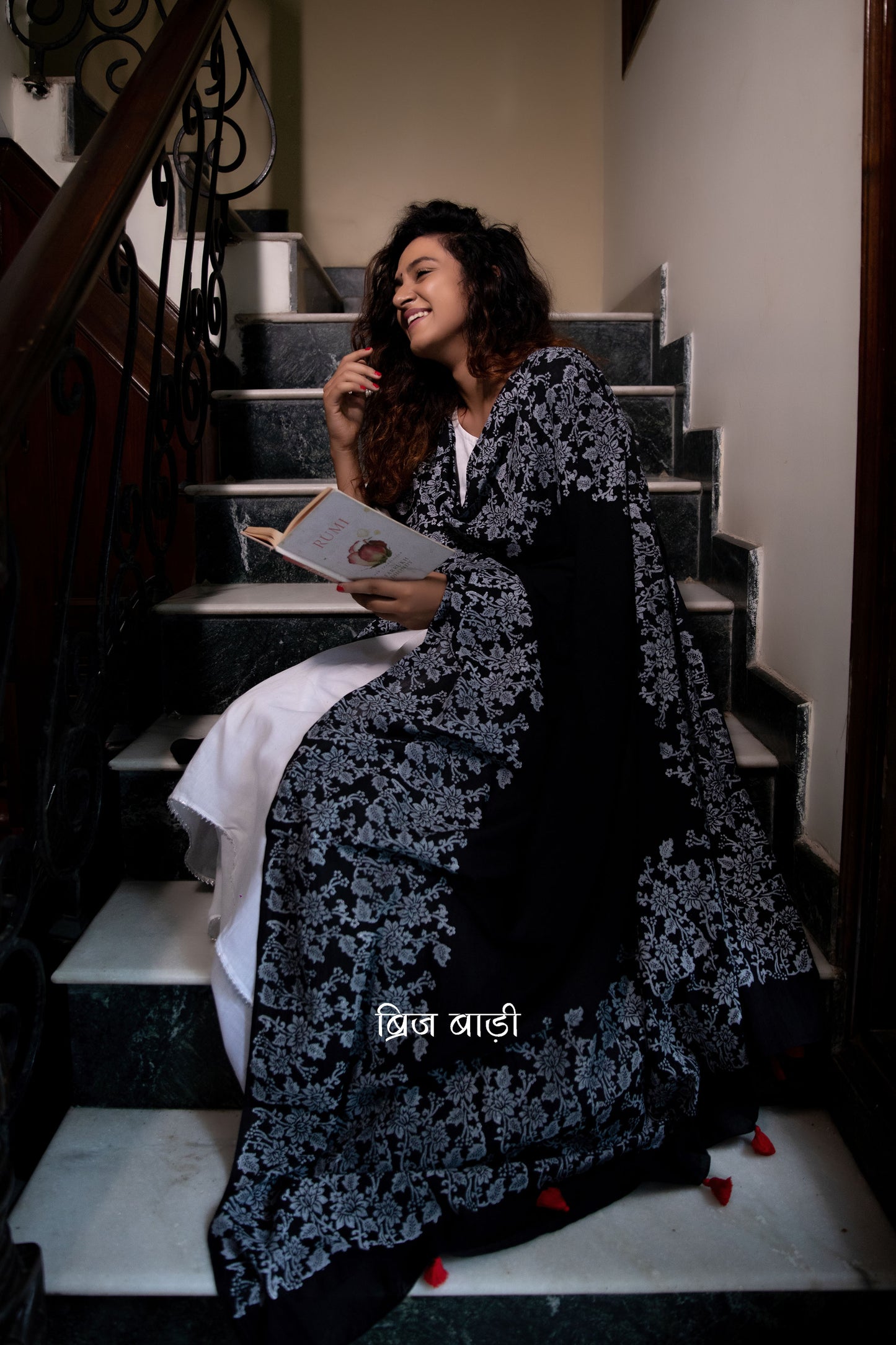 Black soft and light-weight cotton dupatta by Brij Bari, adorned with an elegant floral border hand block printed in white, creating a striking contrast against the deep black base. Crafted from breathable, airy cotton fabric, this dupatta is ideal to pair with suits, kurtas, or ethnic sets, adding a refined handcrafted touch to both everyday and occasion wear. The pallu is finished with vibrant red handmade thread tassels, offering a playful, artisanal accent to the look. 