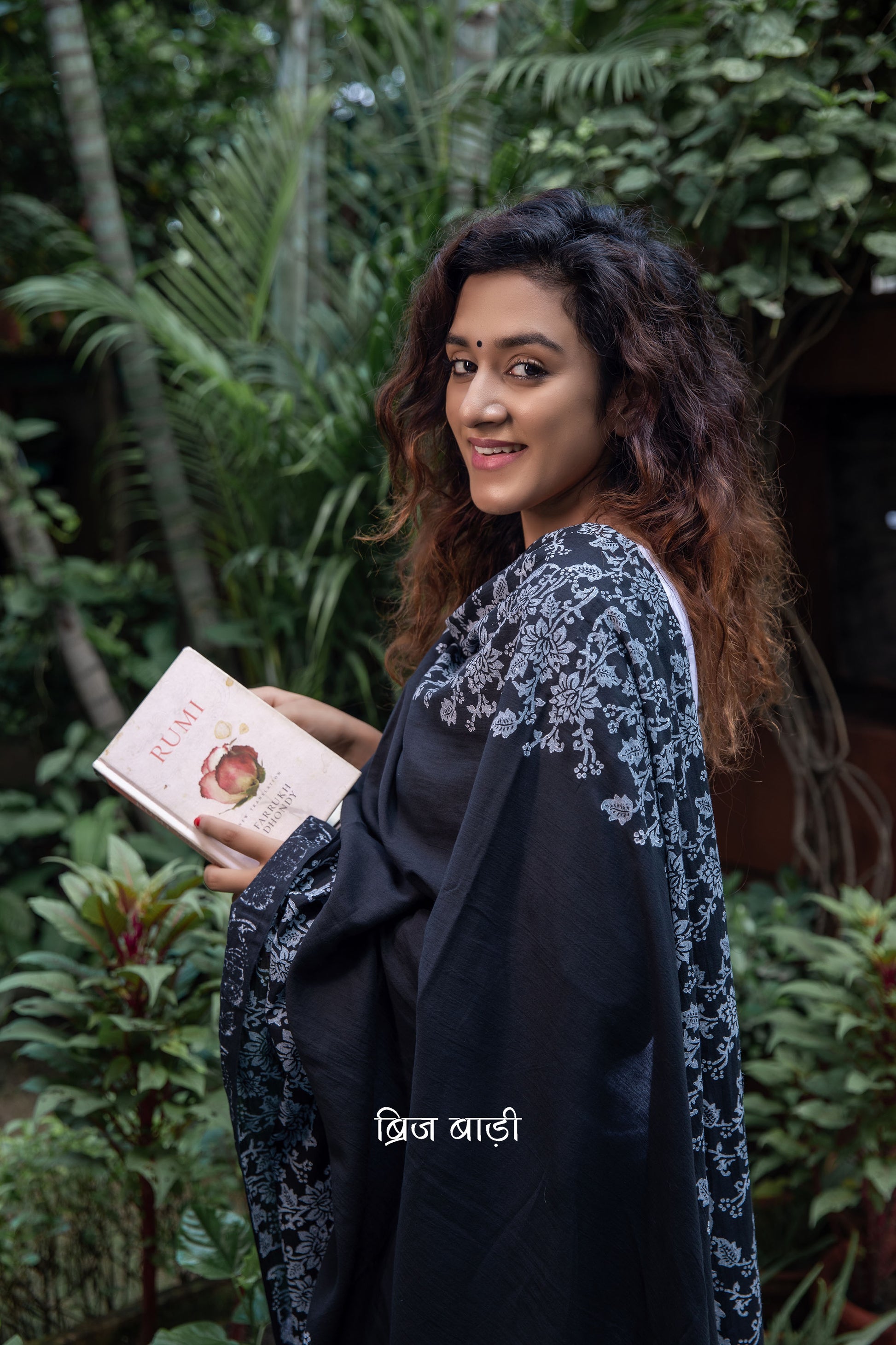 Black soft and light-weight cotton dupatta by Brij Bari, adorned with an elegant floral border hand block printed in crisp white, creating a striking contrast against the deep black base. Crafted from breathable, airy cotton fabric, this dupatta is ideal to pair with suits, kurtas, or ethnic sets, adding a refined handcrafted touch to both everyday and occasion wear. The pallu is finished with vibrant red handmade thread tassels, offering a playful, artisanal accent to the look. 