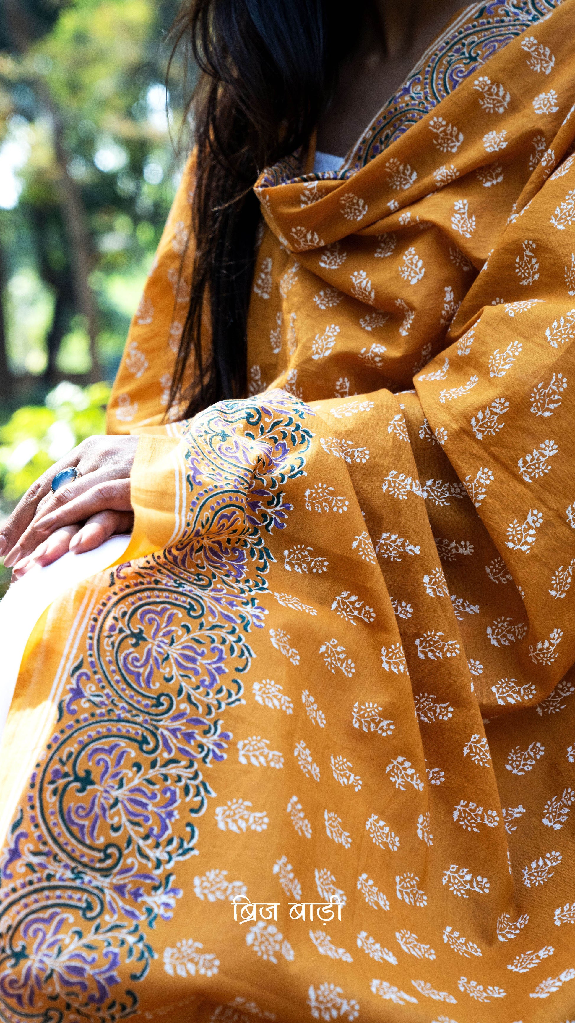 Ochre yellow soft and lightweight cotton dupatta by Brij Bari, hand block printed with a charming floral motif pattern for an artisanal touch. Accented with pink handmade thread tassels on both ends of the pallu, this versatile dupatta adds a vibrant pop to your daily suits, offering breathable comfort and effortless style for all-day wear. Free shipping pan India.