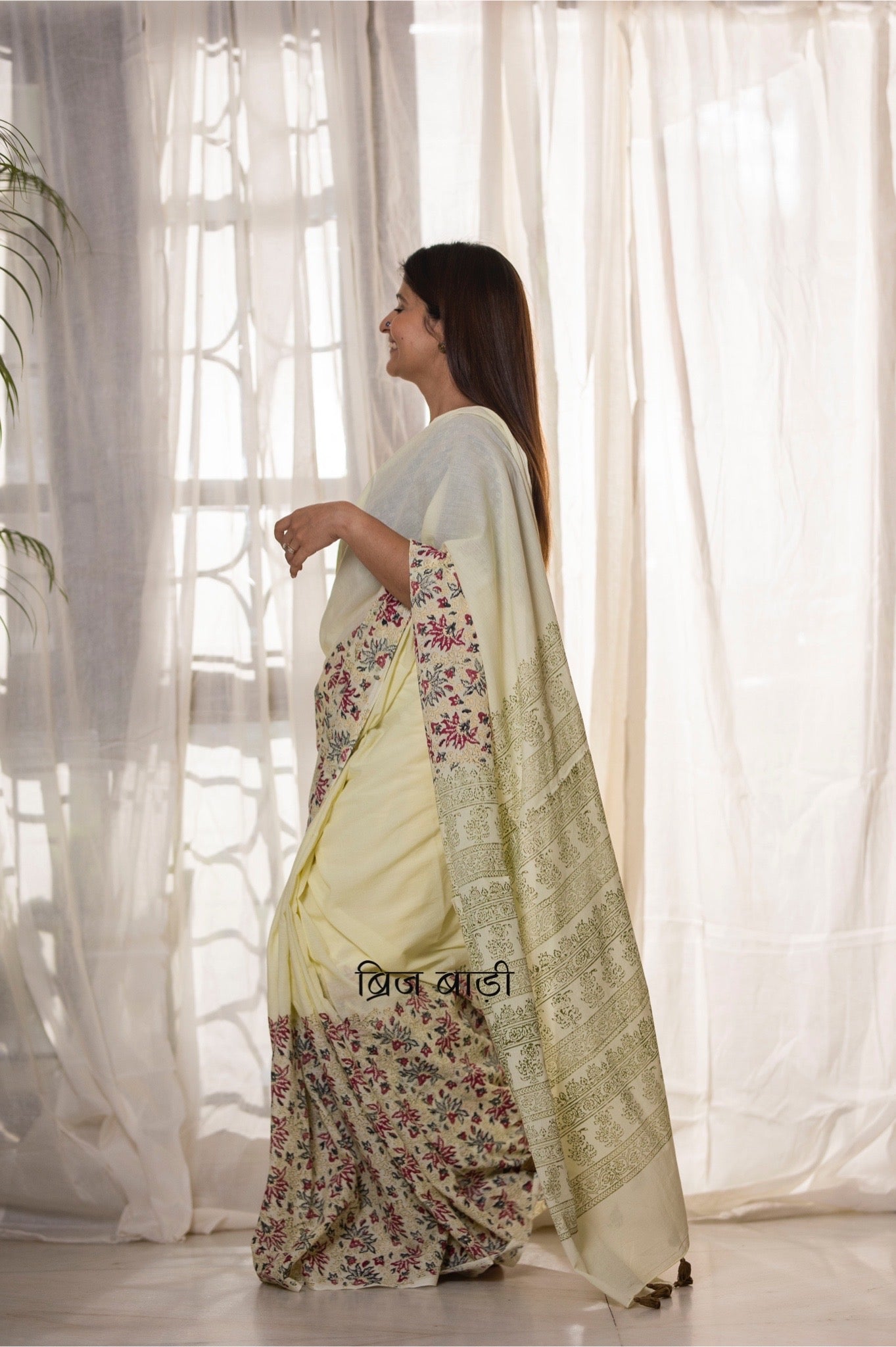 Pastel yellow buttery soft and light-weight cotton saree by Brij Bari, featuring a delicate and intricate multicolour floral hand block print on the skirt, complemented by an olive green floral pattern on the pallu. Detailed with olive green handmade thread tassels on the pallu, this saree comes with a free matching block printed blouse piece. Designed for all-day comfort, effortless elegance, and versatile styling. Free shipping available pan India.