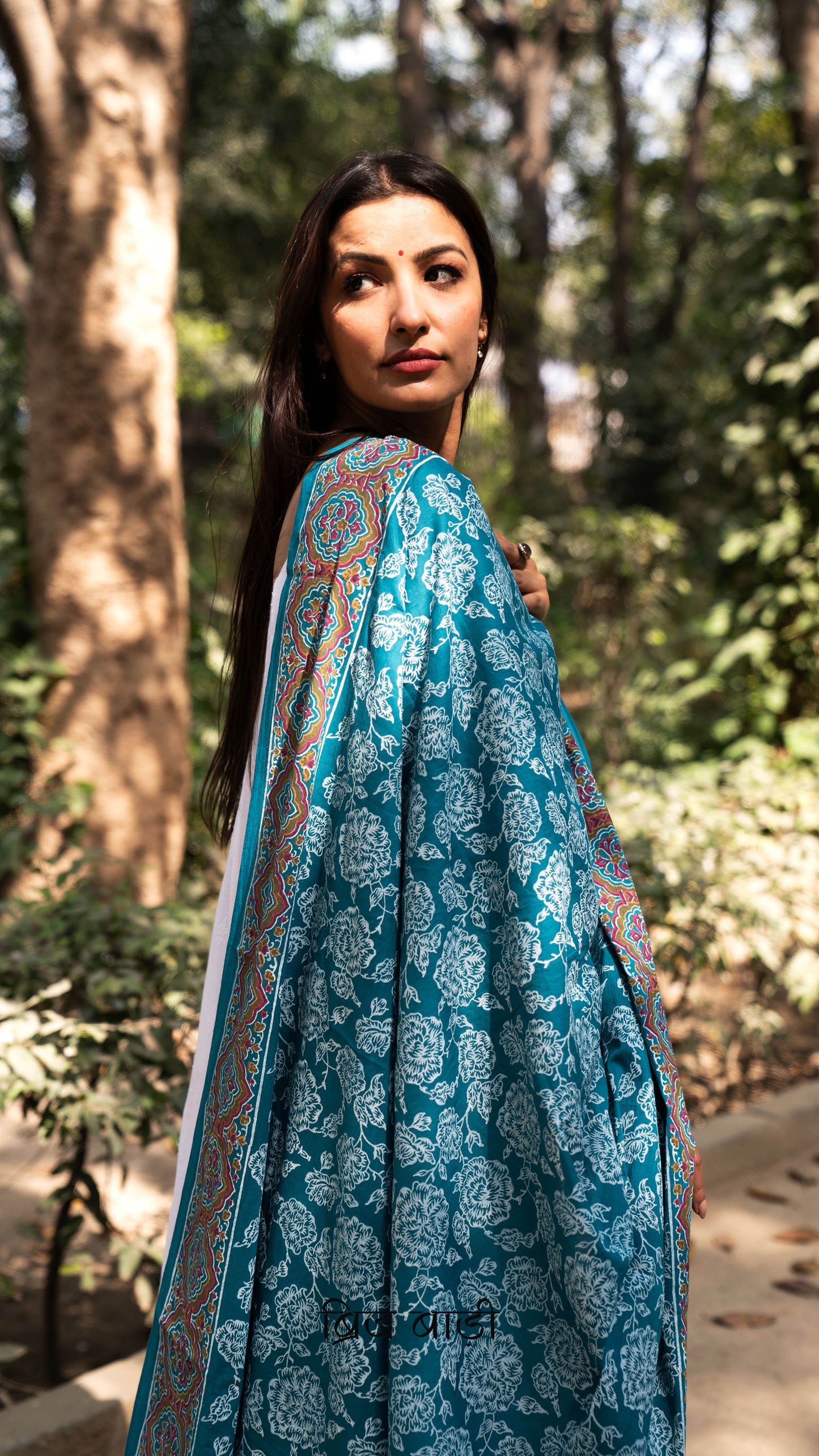 Teal blue soft and lightweight cotton dupatta by Brij Bari, hand block printed with elegant floral motifs across the body and a striking multicolour border. Accentuated with handmade light green thread tassels on both ends of the pallu, this dupatta brings a vibrant, artisanal touch to your everyday suits while offering breathable comfort and versatile styling. Free shipping pan India.