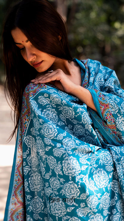 Teal blue soft and lightweight cotton dupatta by Brij Bari, hand block printed with elegant floral motifs across the body and a striking multicolour border. Accentuated with handmade light green thread tassels on both ends of the pallu, this dupatta brings a vibrant, artisanal touch to your everyday suits while offering breathable comfort and versatile styling. Free shipping pan India.